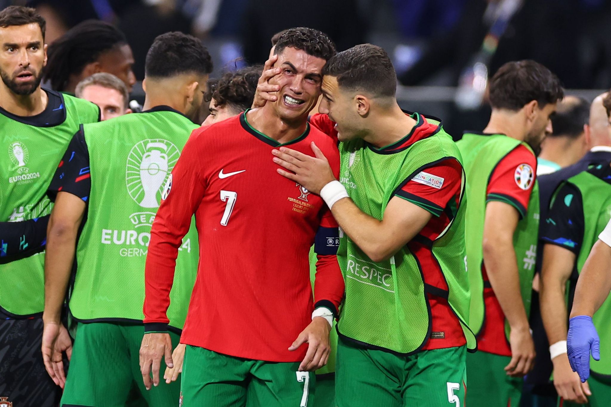 Cristiano Ronaldo is consoled by Diogo Dalot after missing a penalty against Slovenia