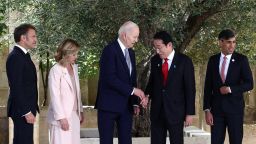 U.S. President Joe Biden and Japan's Prime Minister Fumio Kishida shake hands next to ?Italian Prime Minister Giorgia Meloni, French President Emmanuel Macron and British Prime Minister Rishi Sunak on the first day of the G7 summit at the Borgo Egnazia resort, in Savelletri, Italy June 13, 2024. REUTERS/Guglielmo Mangiapane